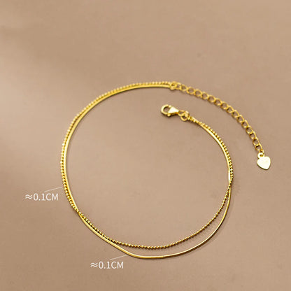 Elegant 14K gold-plated sterling silver anklet with intricate floral pattern and adjustable length
