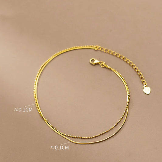 Elegant 14K gold-plated sterling silver anklet with intricate floral pattern and adjustable length