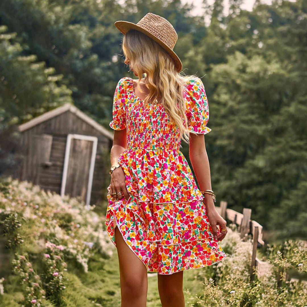 A stylish one-shoulder mini dress with a vibrant floral print, ruffle detailing, and an A-line silhouette.