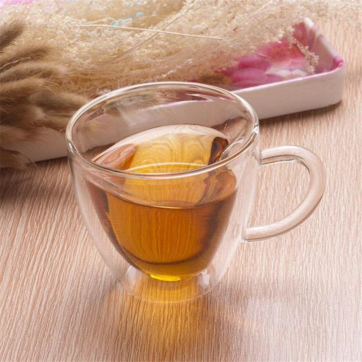 Elegant double heart-shaped ceramic mug in glass, perfect for enjoying hot beverages with a touch of British charm