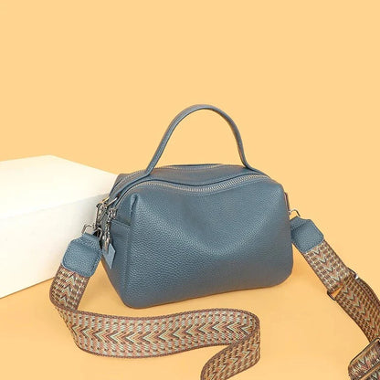 Luxurious genuine leather crossbody bag for women, featuring a soft polyester lining, dual phone pockets, and a compact, square design.