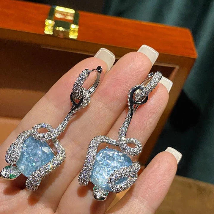 Sophisticated snake-inspired luxury earrings in a copper finish with inlaid gems and semi-precious stones