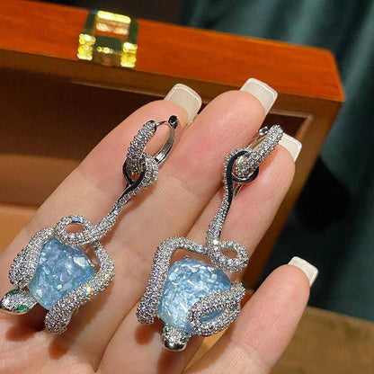 Sophisticated snake-inspired luxury earrings in a copper finish with inlaid gems and semi-precious stones