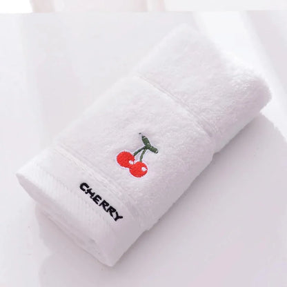 Soft cotton baby bath towel with adorable cartoon fruit face designs in pink