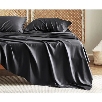 Premium bamboo fibre bed sheets in a classic solid purplish blue colour, featuring a four-piece set including a fitted sheet, flat sheet, and two pillowcases.