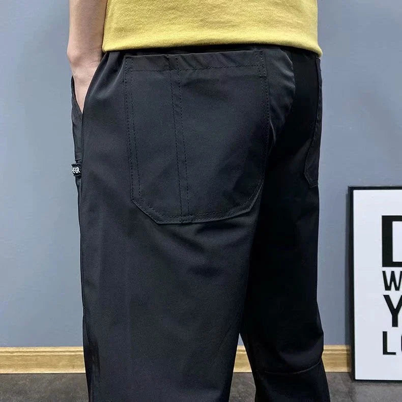 Premium slim-fit drawstring joggers in black and grey, featuring a tailored silhouette and adjustable waistband for a polished, comfortable look.