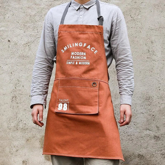 A stylish and practical Nordic-inspired canvas barista apron with a spacious front pocket and adjustable neck strap for a comfortable fit.