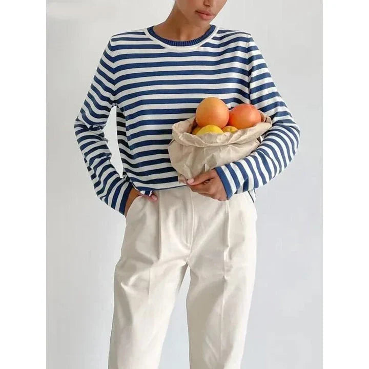 A cosy and stylish knitted stripe jumper for women, featuring a round neckline and full-length sleeves for warmth during the autumn and winter seasons.