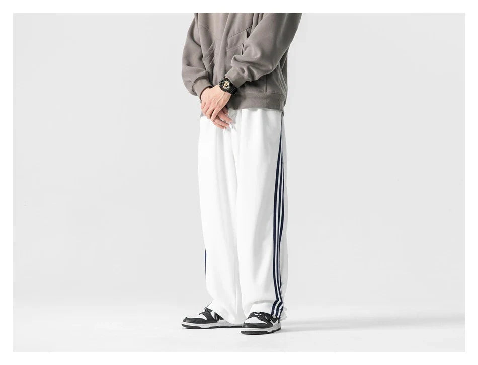 Stylish striped sports trousers in a relaxed, mid-waist design for versatile leisure and athletic wear