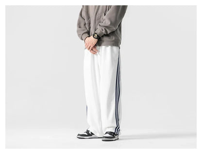Stylish striped sports trousers in a relaxed, mid-waist design for versatile leisure and athletic wear