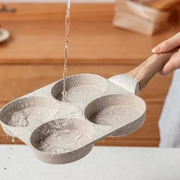 Premium non-stick frying pan with four-hole design for cooking eggs, burgers, and more - a versatile kitchen essential from a British brand