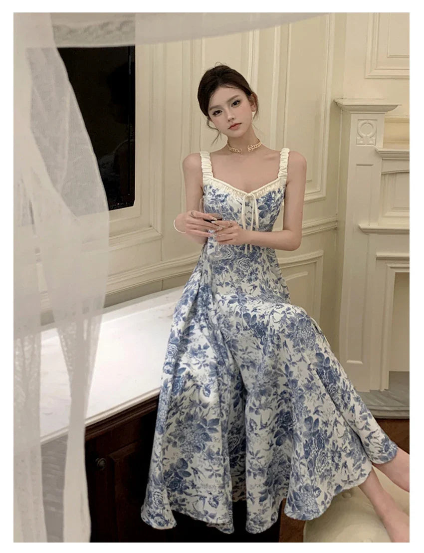 Elegant floral print dress with adjustable straps, A-line silhouette, and high-waisted design for a timeless British fashion look.