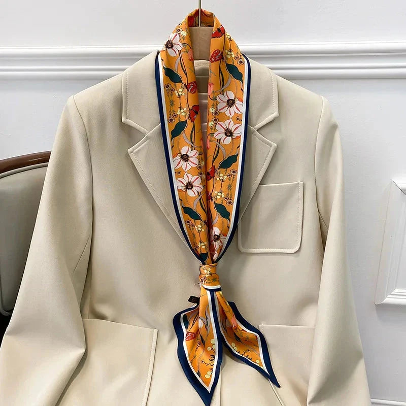 A vibrant floral-patterned silk-feel long scarf that can be worn as a neck accessory, hair tie, or wrist adornment for all occasions.