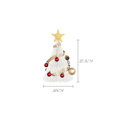 A beautifully crafted origami Christmas tree decoration in a Nordic-inspired style, with a warm, glowing illumination