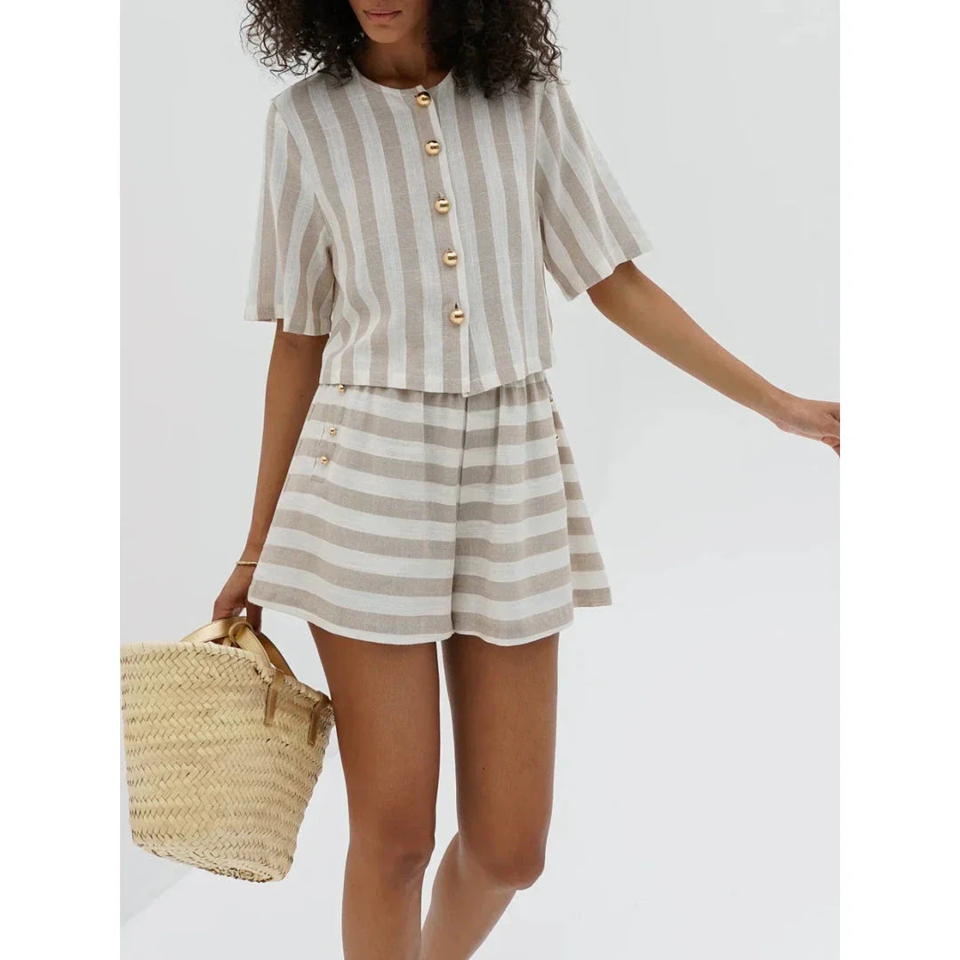 Relaxed and stylish two-piece summer outfit with a striped pattern, featuring a short-sleeved shirt and high-waist shorts.