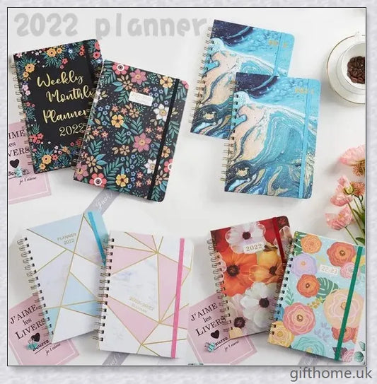 Premium A5 spiral-bound annual calendar notebook with a variety of stylish cover designs including blue art, pink roses, and colourful floral patterns