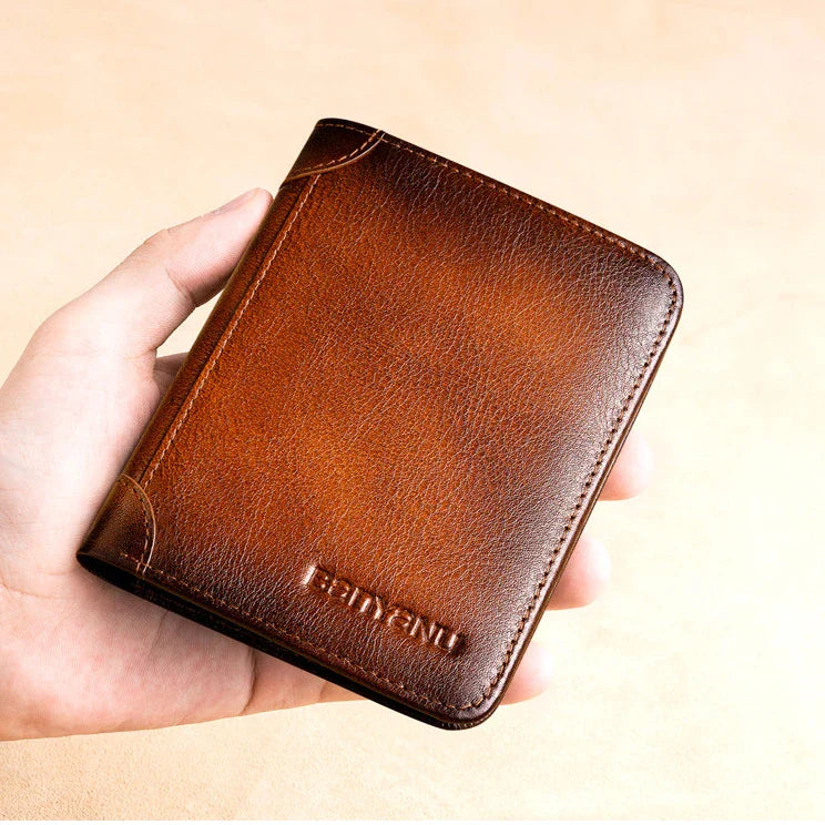 Premium men's short leather wallet with tri-fold design, made from top-grain cowhide leather for exceptional quality and style.