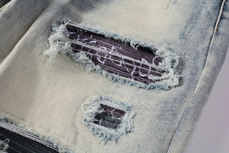 Stylish distressed denim jeans with a skinny, knee-exposed silhouette for a contemporary, high-street fashion look