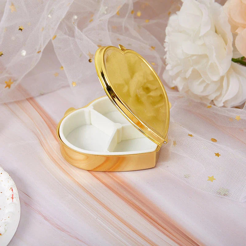 Elegant heart-shaped metal pill box with mirror for organized storage and convenient touch-ups