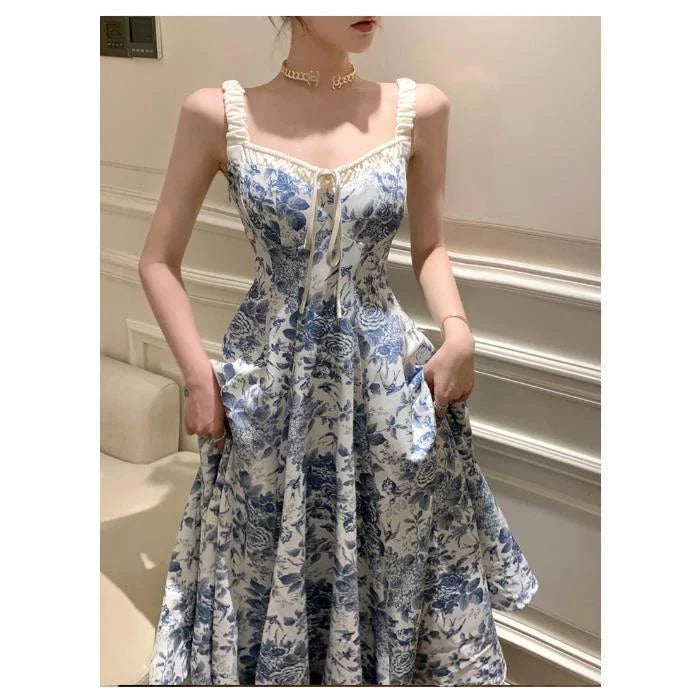 Elegant floral print dress with adjustable straps, A-line silhouette, and high-waisted design for a timeless British fashion look.
