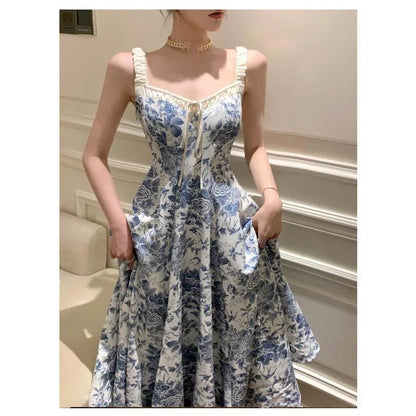 Elegant floral print dress with adjustable straps, A-line silhouette, and high-waisted design for a timeless British fashion look.