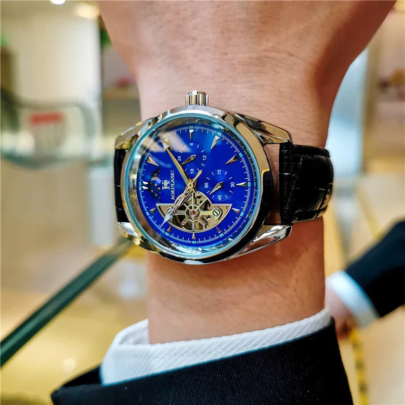 Elegant men's automatic mechanical watch with exquisite hollowed-out design, featuring luminous hands, moon phase display, and small seconds subdial.