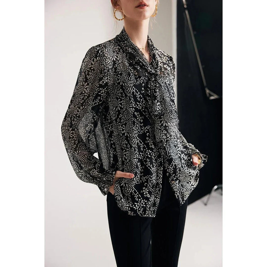 Elegant black silk blouse with unique bow collar, designed for a flattering fit and all-day comfort.