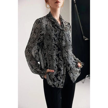 Elegant black silk blouse with unique bow collar, designed for a flattering fit and all-day comfort.