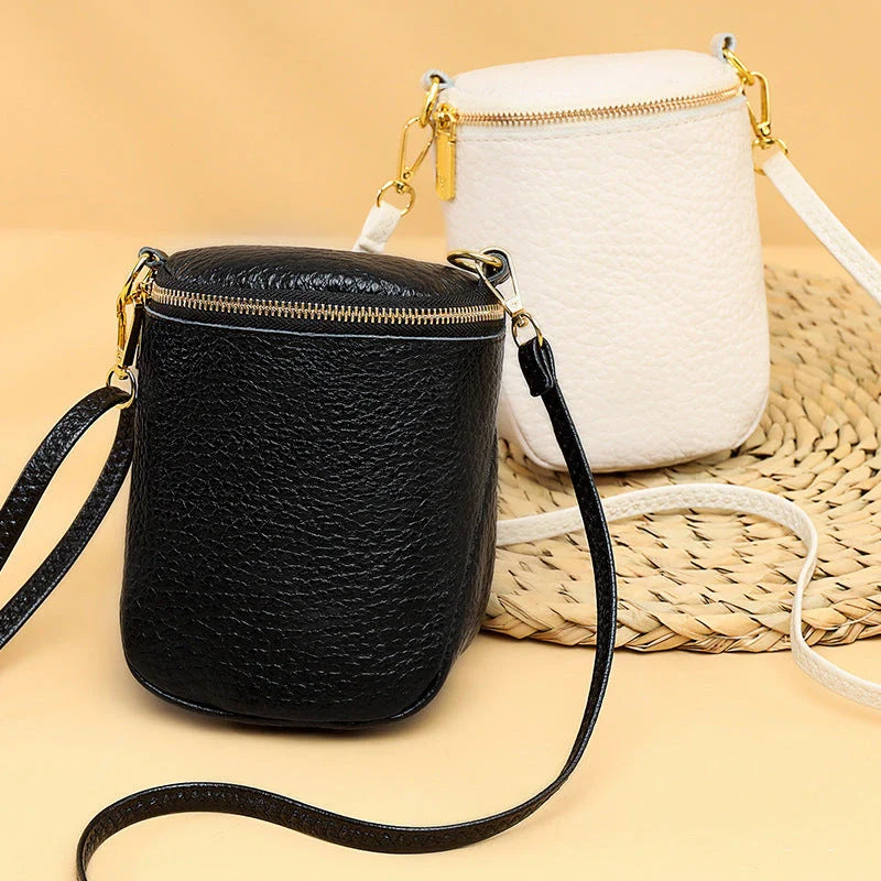 Elegant leather crossbody bag with adjustable strap, multiple pockets, and premium cowhide construction for the modern British woman