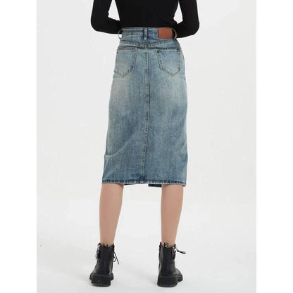 A high-waist denim pencil skirt with a classic A-line silhouette, perfect for the modern British woman.