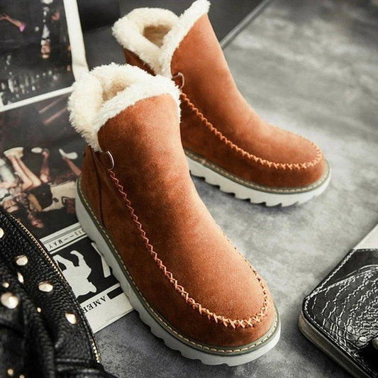 A pair of stylish, non-slip snow boots with a warm artificial wool lining, perfect for British winter weather
