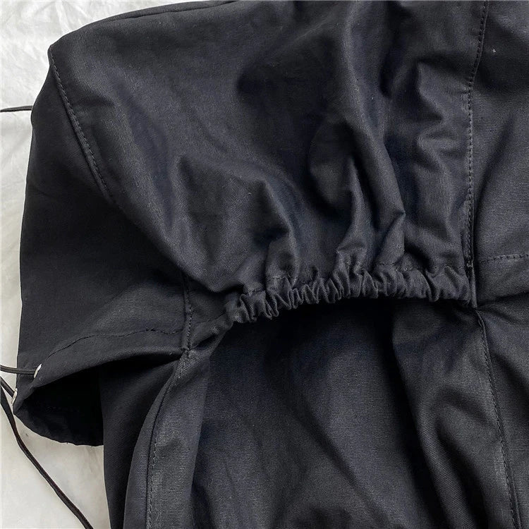 A stylish drawstring bucket bag in white, black, or brown colour options, featuring a spacious interior and adjustable closure for modern British women.