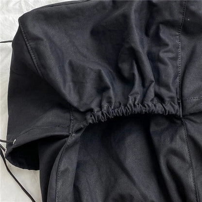 A stylish drawstring bucket bag in white, black, or brown colour options, featuring a spacious interior and adjustable closure for modern British women.