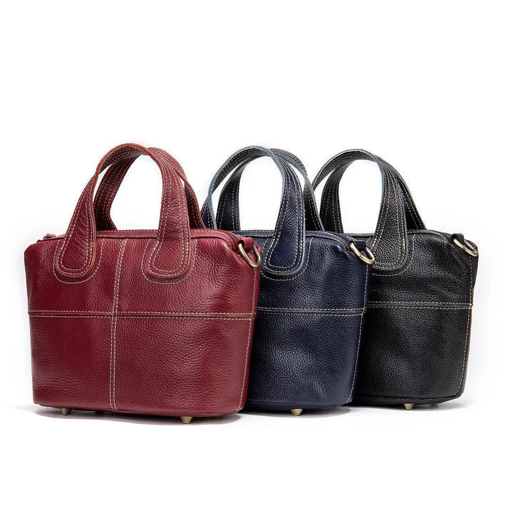Premium leather shoulder bag for women in red, blue, and black colours with spacious interior and comfortable strap