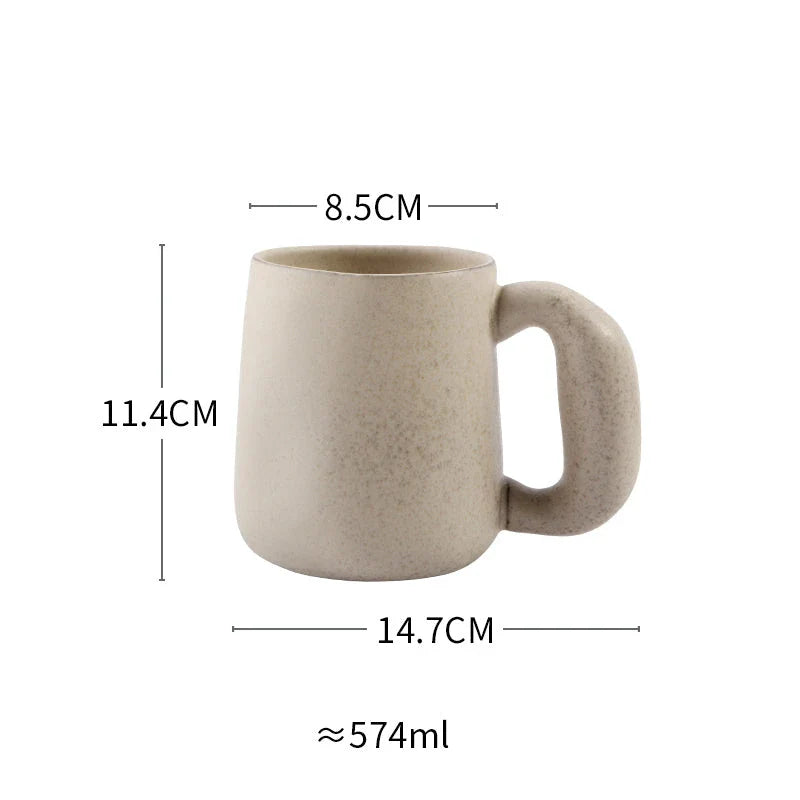 Handcrafted Japanese ceramic retro coffee mug in solid apricot or grey colour, featuring a comfortable handgrip design for enhanced daily beverage enjoyment.