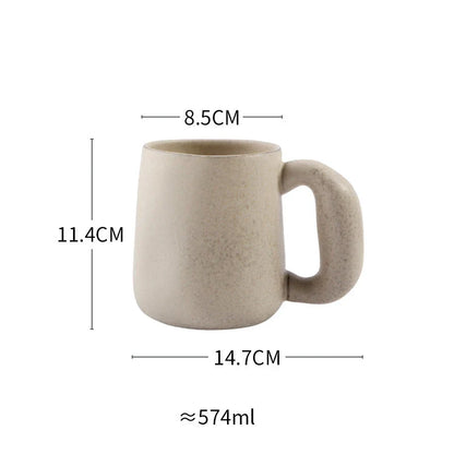 Handcrafted Japanese ceramic retro coffee mug in solid apricot or grey colour, featuring a comfortable handgrip design for enhanced daily beverage enjoyment.