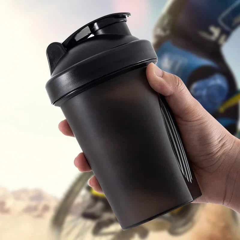 Premium protein shaker bottle with stainless steel whisk ball, BPA-free plastic, and leak-proof design for on-the-go fitness enthusiasts in the UK.