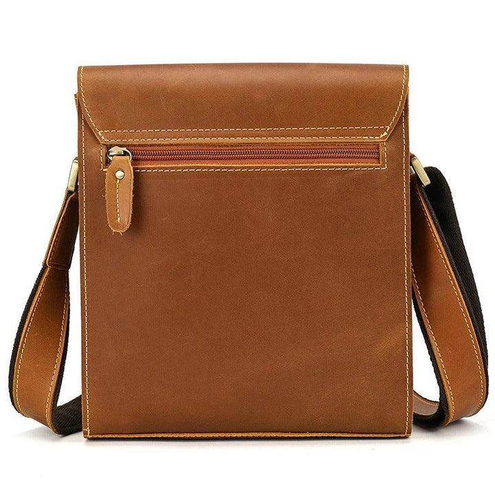 Premium leather crossbody bag with flap closure, vertical square shape, and multiple interior compartments