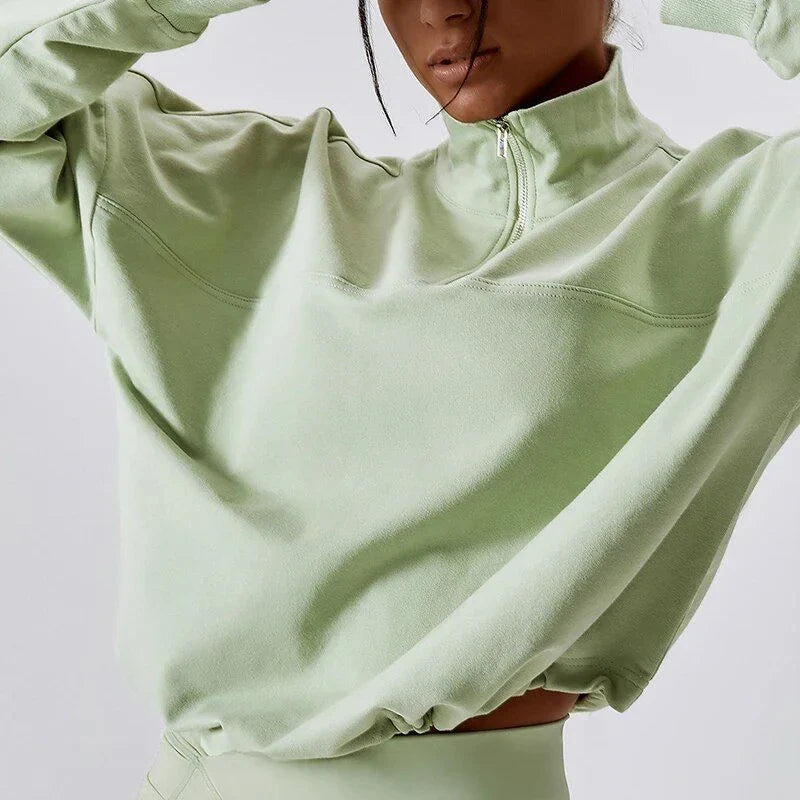 A cosy, oversized cotton pullover with a stylish zipper accent, perfect for casual autumn and winter wear.