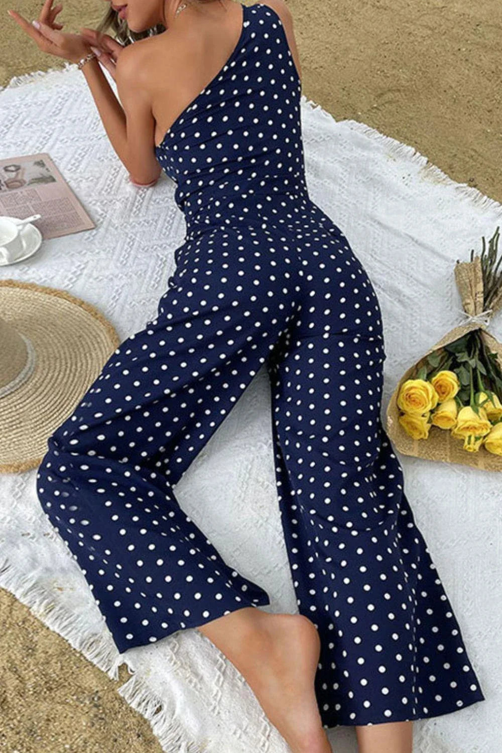 A stylish one-shoulder polka dot jumpsuit with a flattering, figure-hugging silhouette