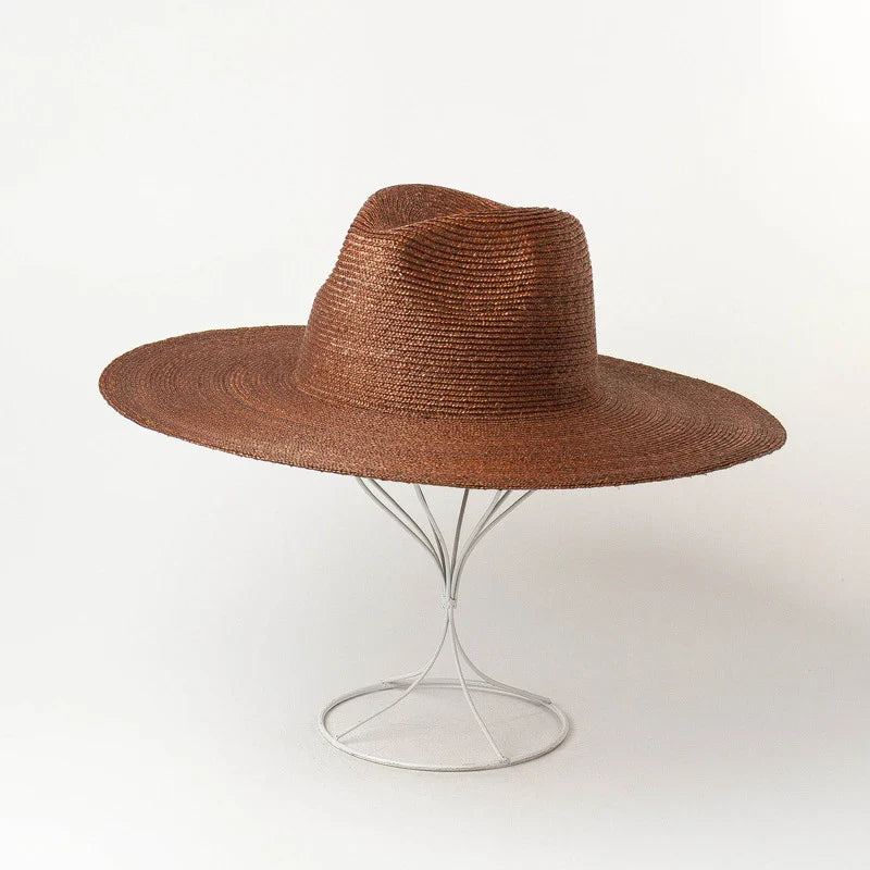 Premium outdoor sun protection straw hat in black, brown, and pinkish colours with a large brim and tie-dye pattern