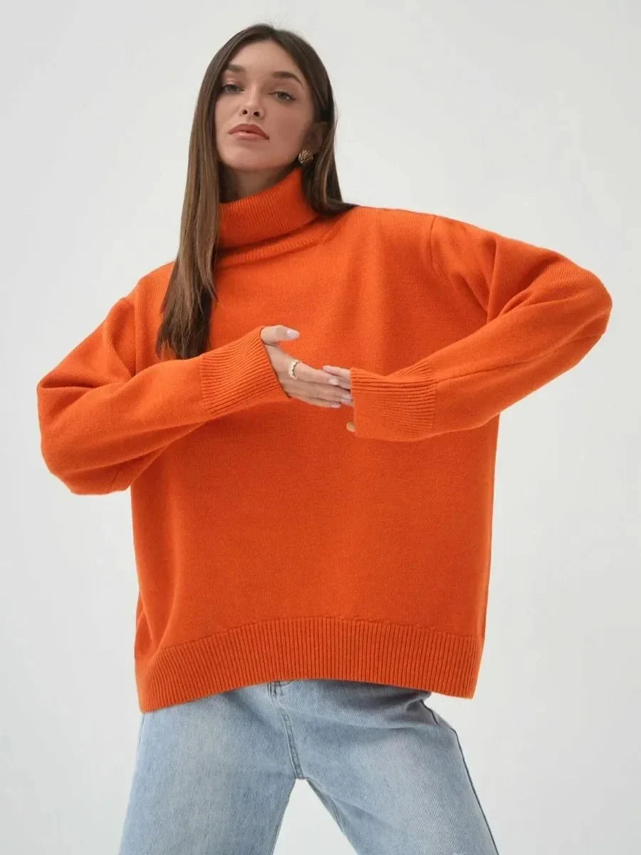 Cosy oversized knitted pullover in blue, featuring a classic turtleneck collar and drop-shoulder silhouette for maximum comfort and style.