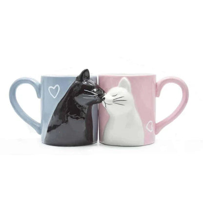 A pair of ceramic mugs featuring a charming design of two kissing cats, perfect for couples and cat lovers