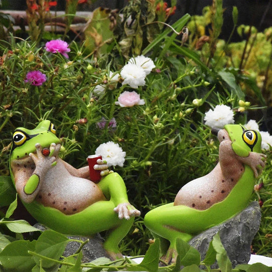 Charming resin frog garden ornaments in various poses and colours, perfect for adding a whimsical touch to outdoor spaces.