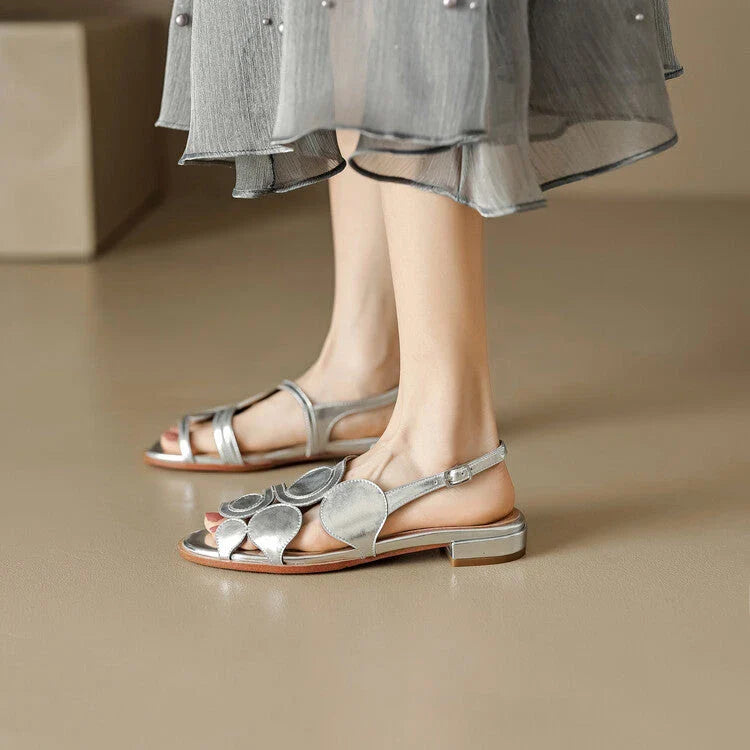 Chic sheepskin round toe sandals with a chunky heel and hollow out design, featuring a secure back strap and a modern, versatile style