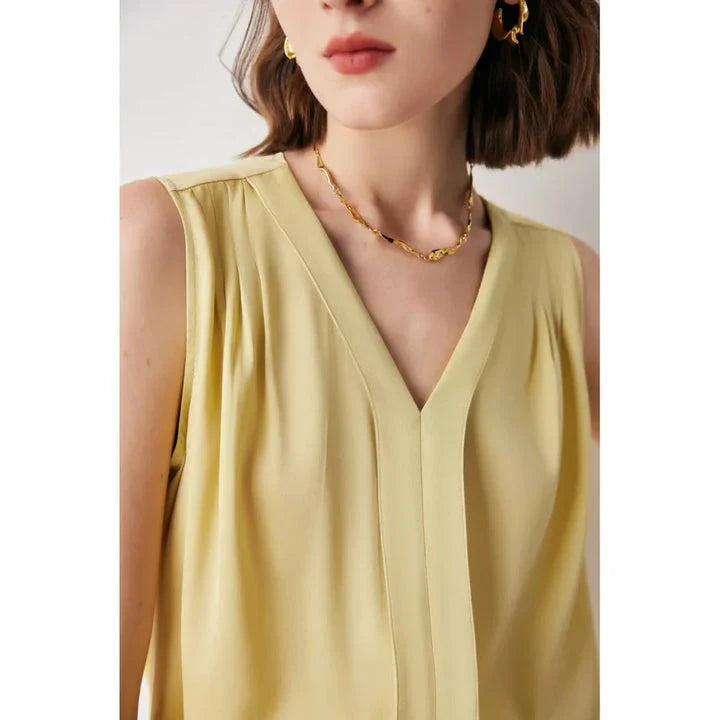 Elegant sleeveless silk blouse in a vibrant blue colour, designed for a sophisticated summer style