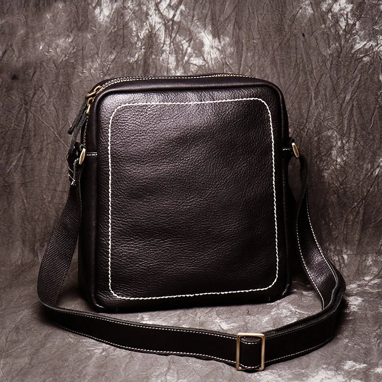 A premium cowhide leather satchel bag with a single shoulder strap, designed for the discerning British gentleman