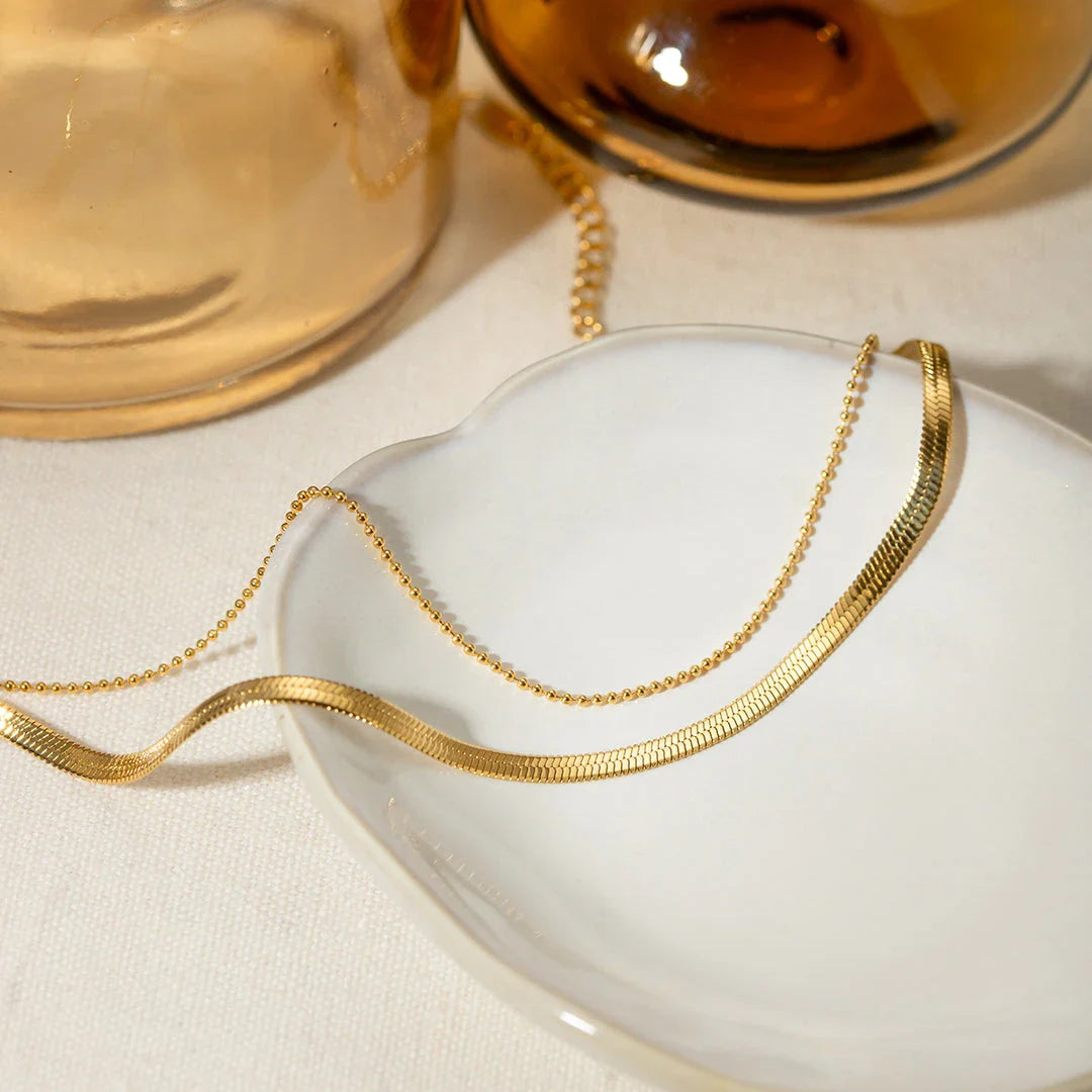 Exquisite 18K gold-plated double layer snake chain anklet with a durable stainless steel base, designed to elevate summer style with timeless elegance.