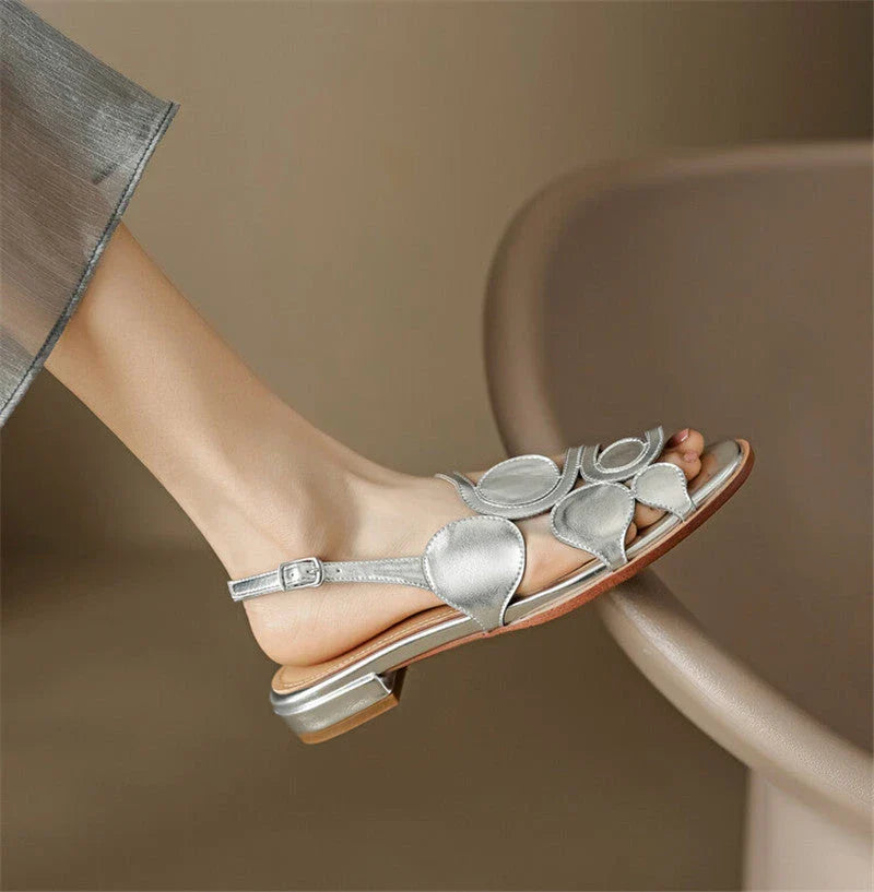 Chic sheepskin round toe sandals with a chunky heel and hollow out design, featuring a secure back strap and a modern, versatile style