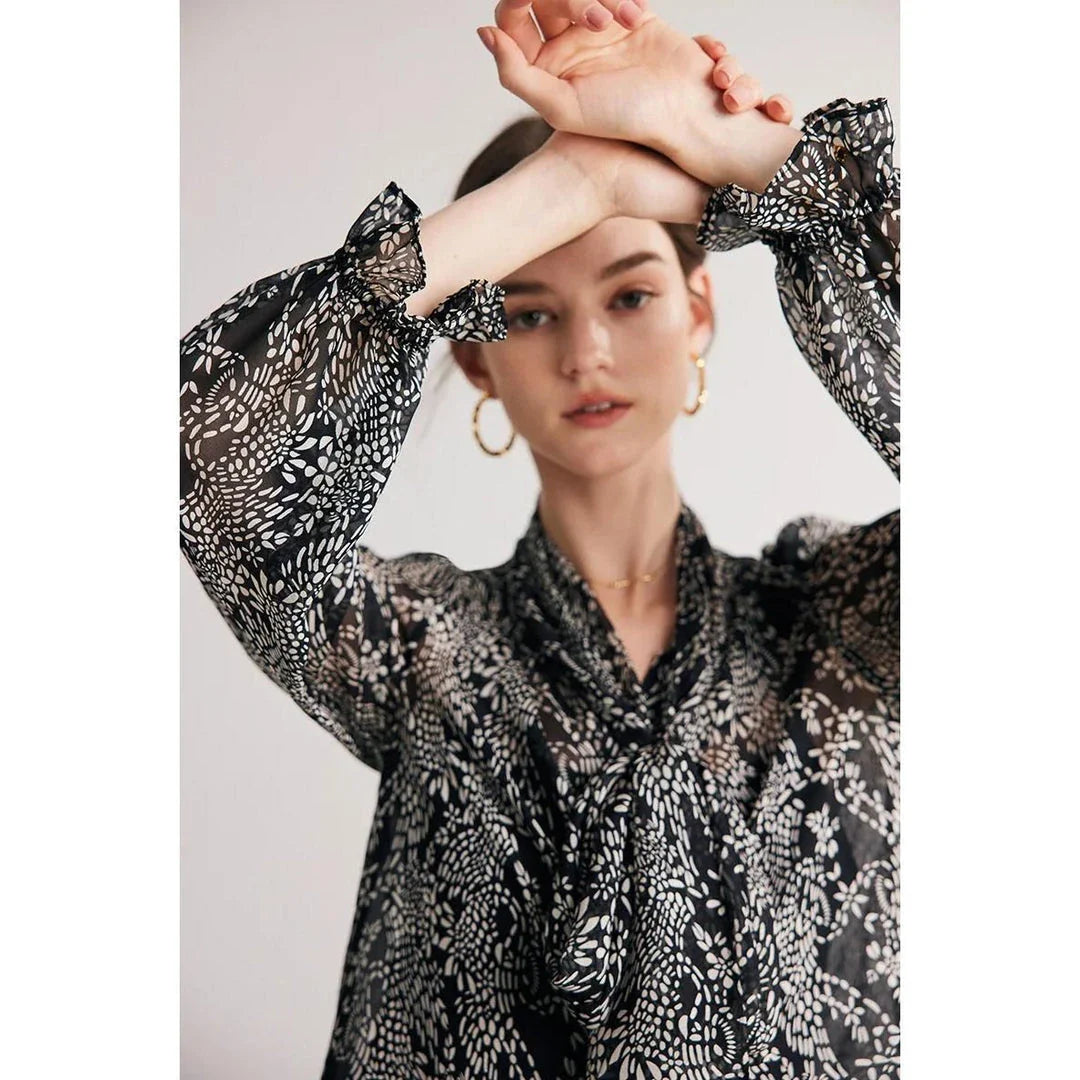 Elegant black silk blouse with unique bow collar, designed for a flattering fit and all-day comfort.